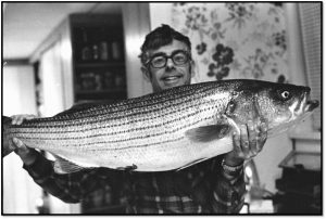 William L. Guggenheim and his favorite fish, a Striped Bass caught off the New Jersey coast. (Photo: Ann Guggenheim, 1976) 