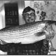 William L. Guggenheim and his favorite fish, a Striped Bass caught off the New Jersey coast. (Photo: Ann Guggenheim, 1976)